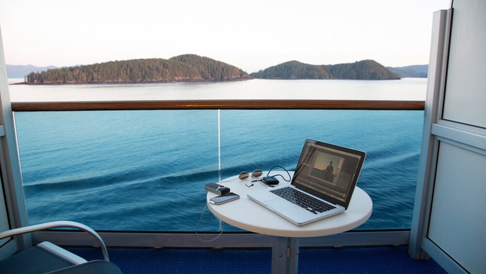 View from cruise ship with laptop on table, Alaska, USA